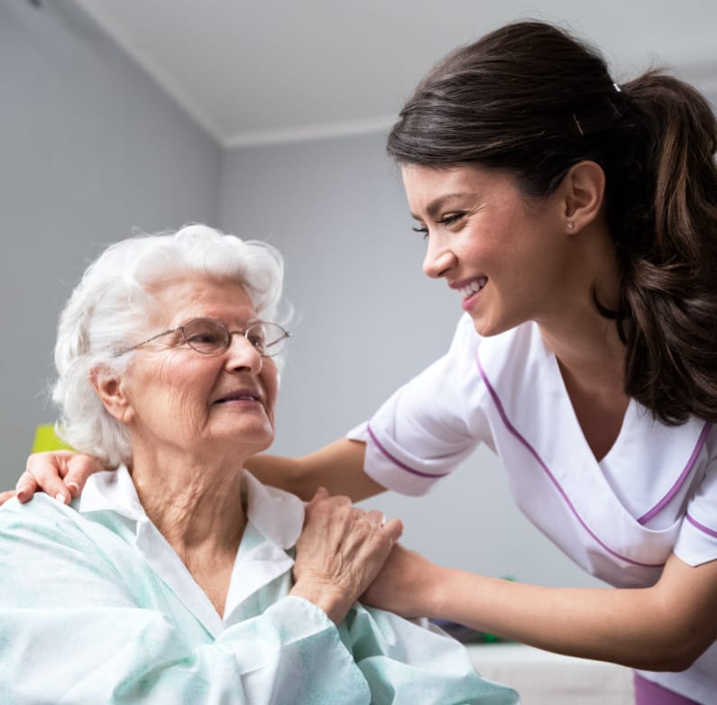 care taker helping elderly woman