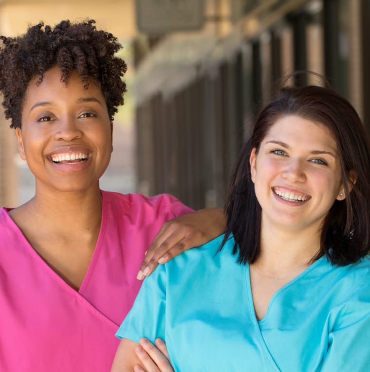 two nurse aides smiling