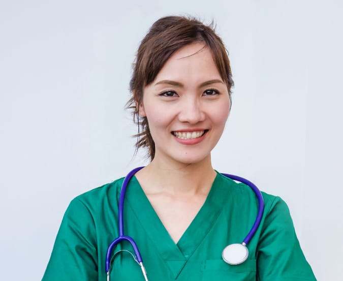 headshot of nurse in green scrubs