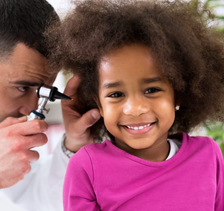 doctor checking child's ear