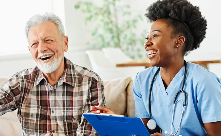 young nurse laughing with senior client